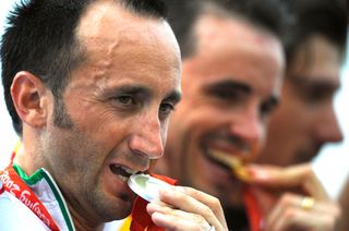 Davide Rebellin poses with the silver medal at the Beijing Olympics. Samuel Sanchez and Fabian Cancellara are alongside him on the podium.