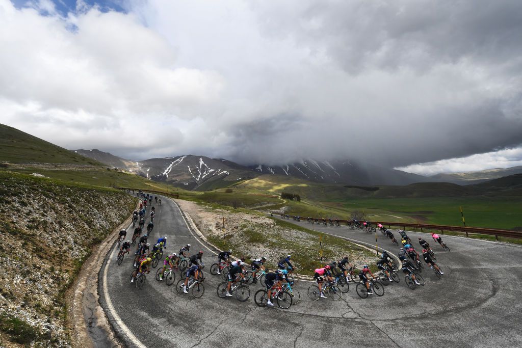 ASCOLI PICENO SAN GIACOMO ITALY MAY 13 Giulio Ciccone of Italy and Team Trek Segafredo Simon Carr of United Kingdom and Team EF Education Nippo Guy Niv of Israel and Team Israel StartUp Nation The peloton passing through Forca di Gualdo 1490m mountain landscape during the 104th Giro dItalia 2021 Stage 6 a 160km stage from Grotte di Frasassi to Ascoli Piceno San Giacomo 1090m Landscape Mountains girodiitalia Giro UCIworldtour on May 13 2021 in Ascoli Piceno San Giacomo Italy Photo by Tim de WaeleGetty Images