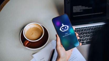 A stock photo of a woman speaking to an AI chatbot.