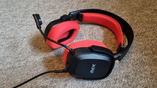 The XPG Precog wired gaming headset on a neutral carpeted background. 