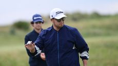 Sampson Zheng holds his golf ball up to the crowd during The Open Championship Final Qualifying at West Lancashire Golf Club in July 2025