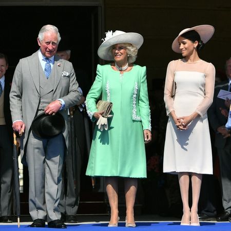King Charles, Queen Camilla and Meghan Markle standing in a row