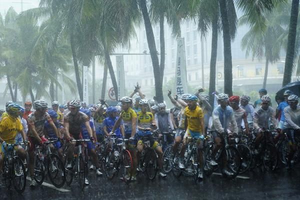 Riders before the start of stage six, when heavy rains hit Haikou and would ultimately force its cancellation.
