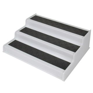 A white plastic three tier shelf riser with grey rubber shelves 