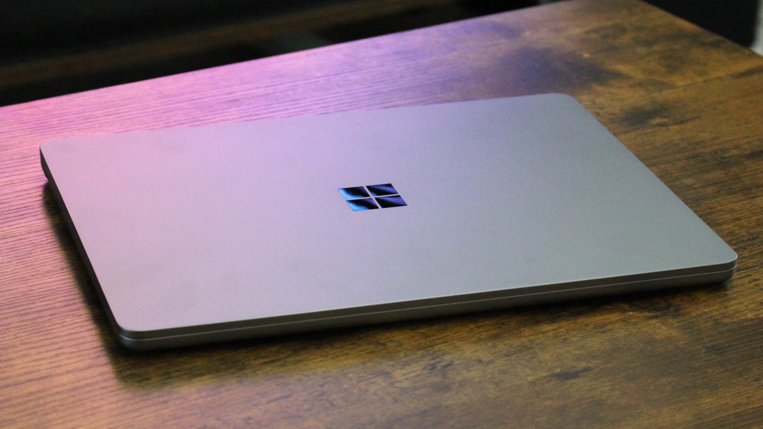 Surface Laptop 13-inch closed on a wooden table.