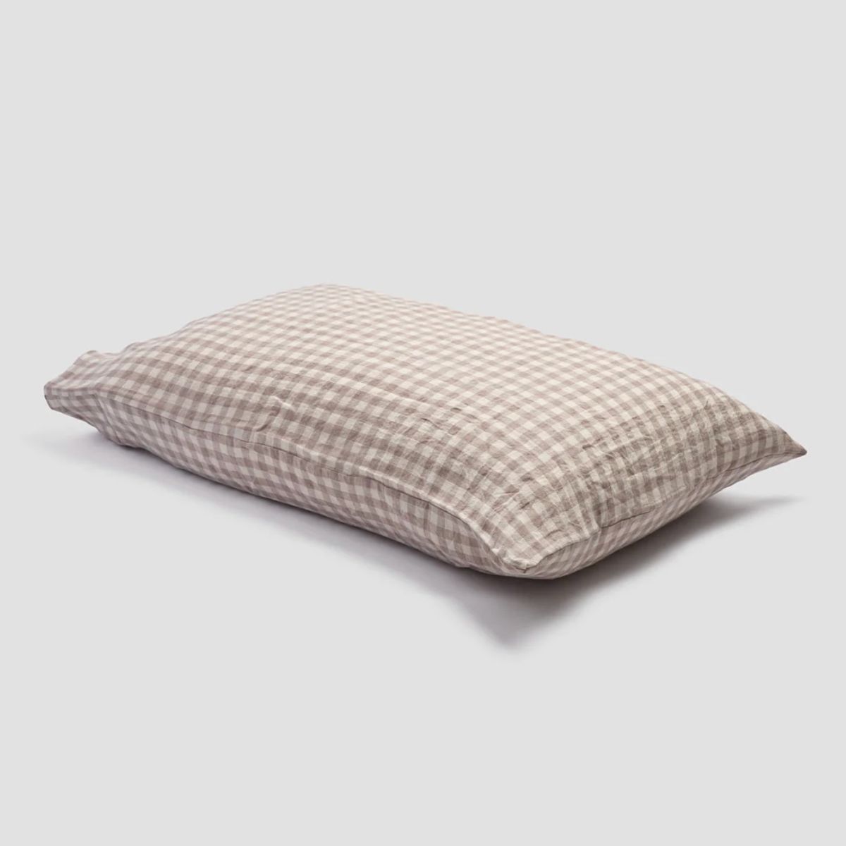 A gingham pillow case in a neutral color