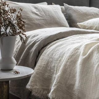 neutral oatmeal colored bedding on a bed