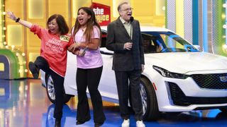 Drew Carey celebrating with contestants on The Price Is Right at Night