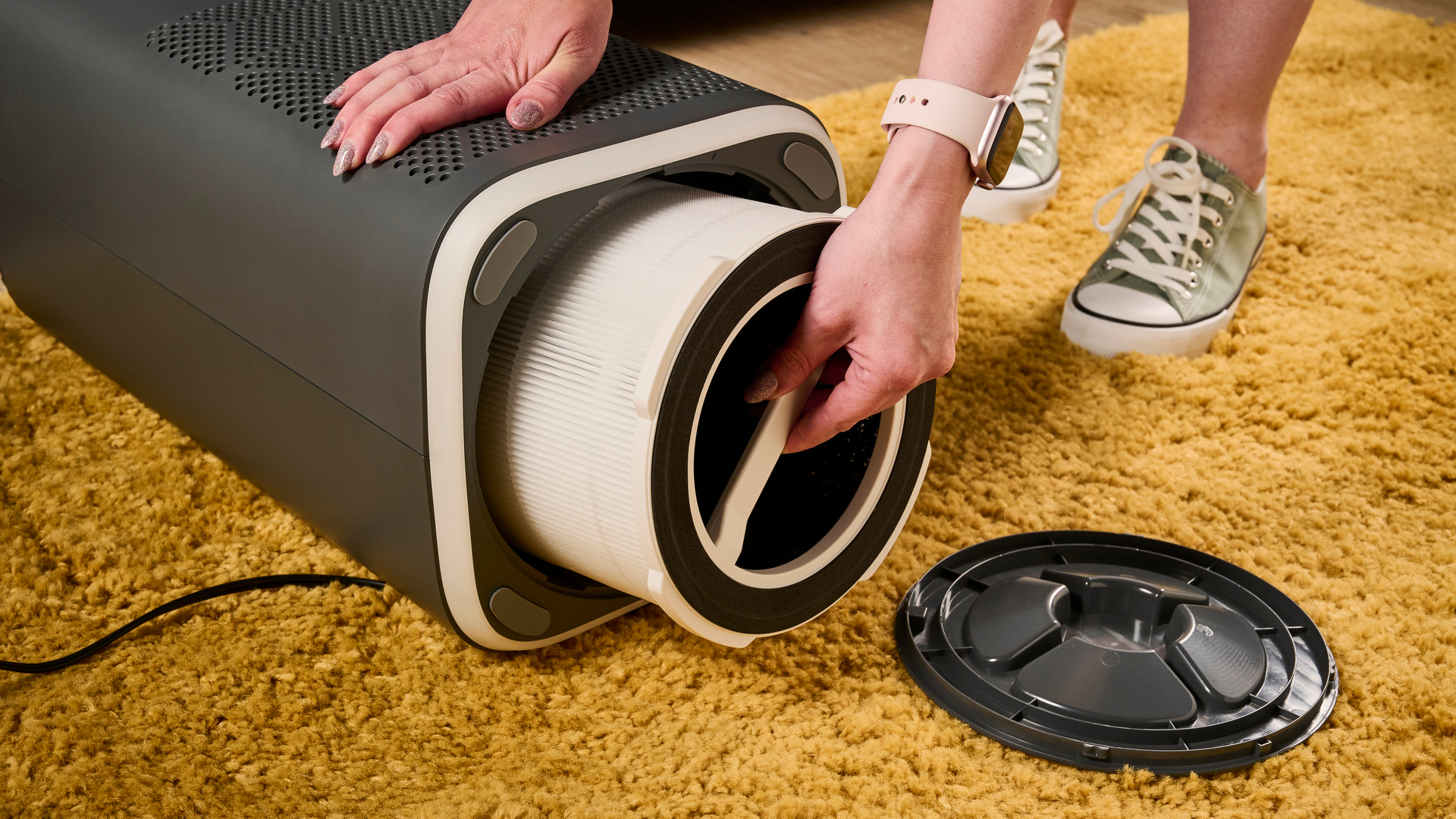 The picture shows the HEPA filter being removed through the base of the AiDot Welove P200 Pro air purifier.