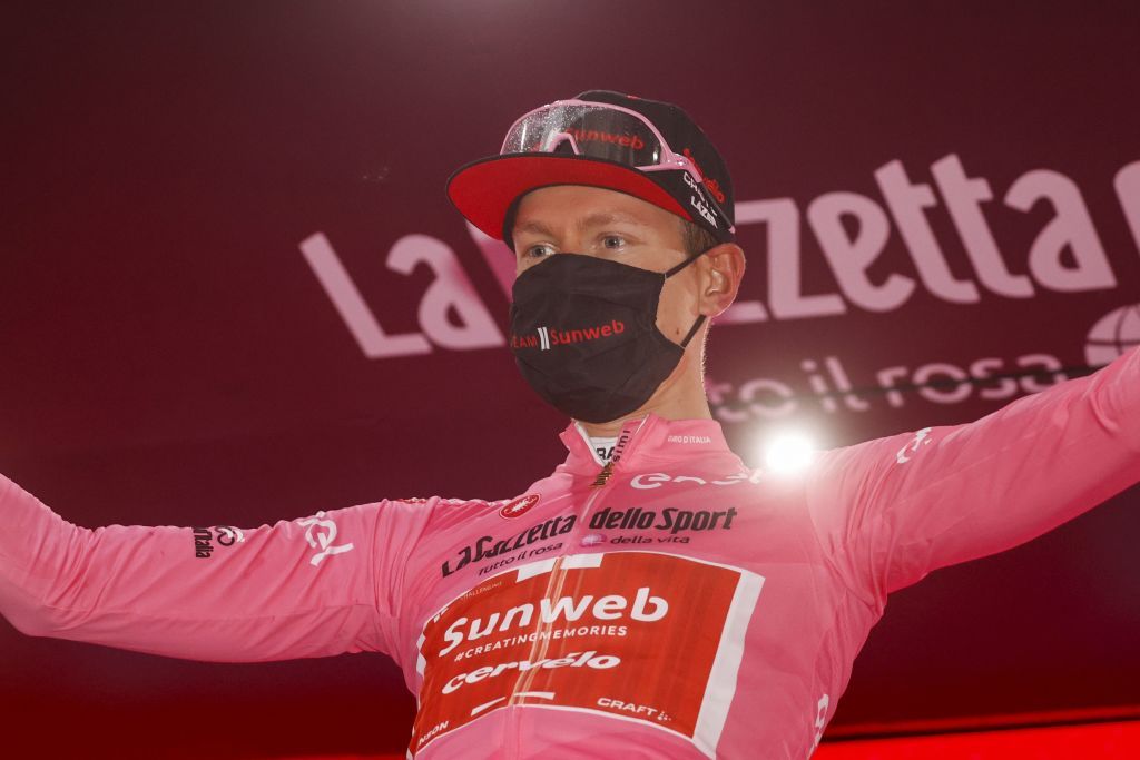 Team Sunweb rider Netherlands Wilco Kelderman wearing the overall leaders pink jersey celebrates on the podium after the 19th stage of the Giro dItalia 2020 cycling race a 258kilometer route between Morbegno and Asti on October 23 2020 Heavy rain has interrupted on October 23 2020 the 19th stage of the Giro dItalia following protests by the riders in the face of difficult weather conditions Todays stage was planned to be a flat 258km ride between Morbegno and Asti but was cut back 100km after riders revolted when faced with pelting rain in the northern region of Lombardy Photo by Luca Bettini AFP Photo by LUCA BETTINIAFP via Getty Images