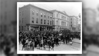 Black and white photo of crowd of people in a parade in Virginia for Juneteenth 1905