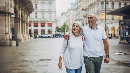 A senior couple who have retired abroad from the U.S., enjoying their new city.