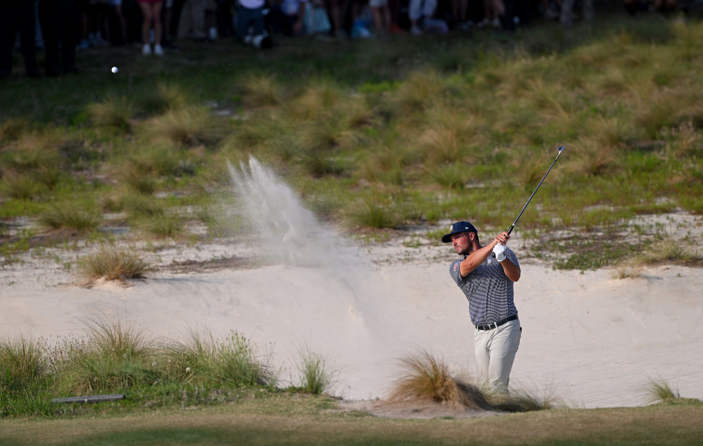 Bryson DeChambeau of the U.S. plays his third shot out of a greenside bunker on the 18th hole during the final round of the 124th U.S. Open at Pinehurst Resort on June 16, 2024 in Pinehurst, North Carolina. (Photo by Ross Kinnaird/Getty Images)