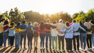 A line of people with their arms around each other