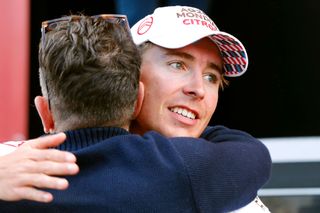 Cosnefroy is consoled by his team director at the podium