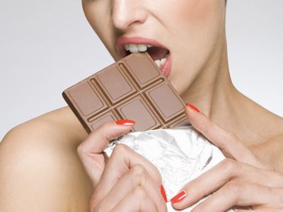 woman eating chocolate bar