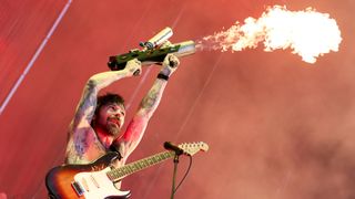Biffy Clyro frontman Simon Neil holds a flamethrower during their Finsbury Park headline show
