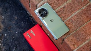 OnePlus 11 Arbor Green colorway with its bright red box