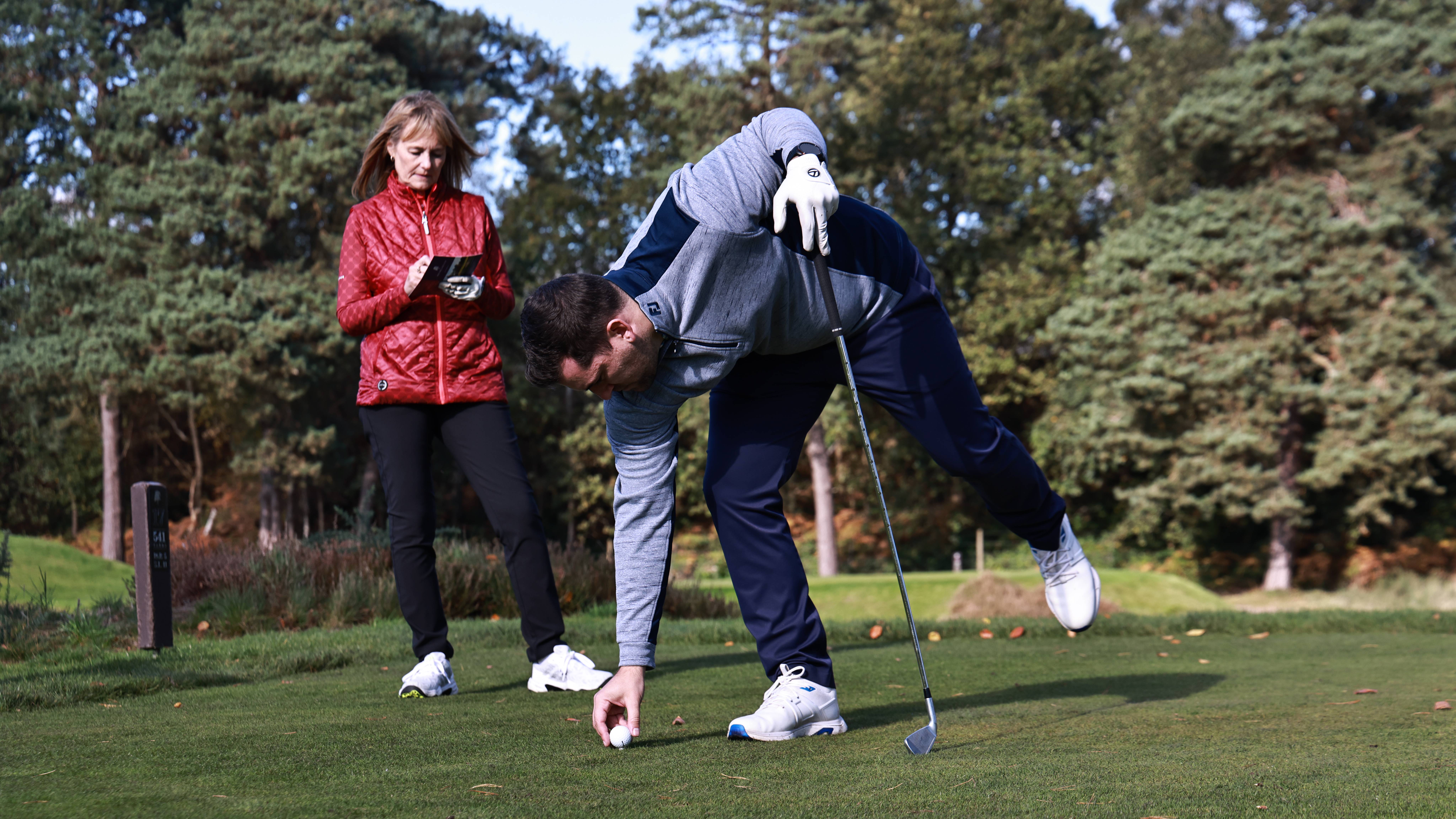 Golfer on tee marking a scorecard