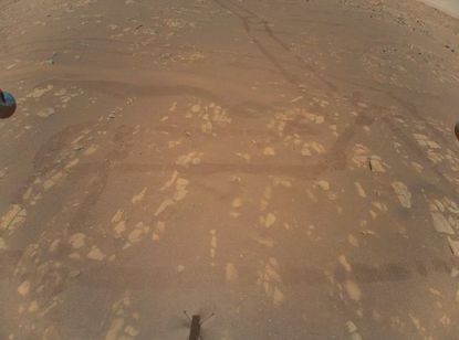 This photo, snapped on April 22, 2021 by NASA's Mars helicopter Ingenuity, shows tracks made by the Perseverance rover on Jezero Crater's floor. “This is the first color image of the Martian surface taken by an aerial vehicle while it was aloft,” NASA officials wrote.