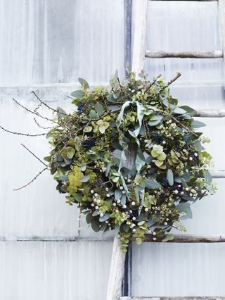 Natural wreath with berries and a delicate mint ribbon