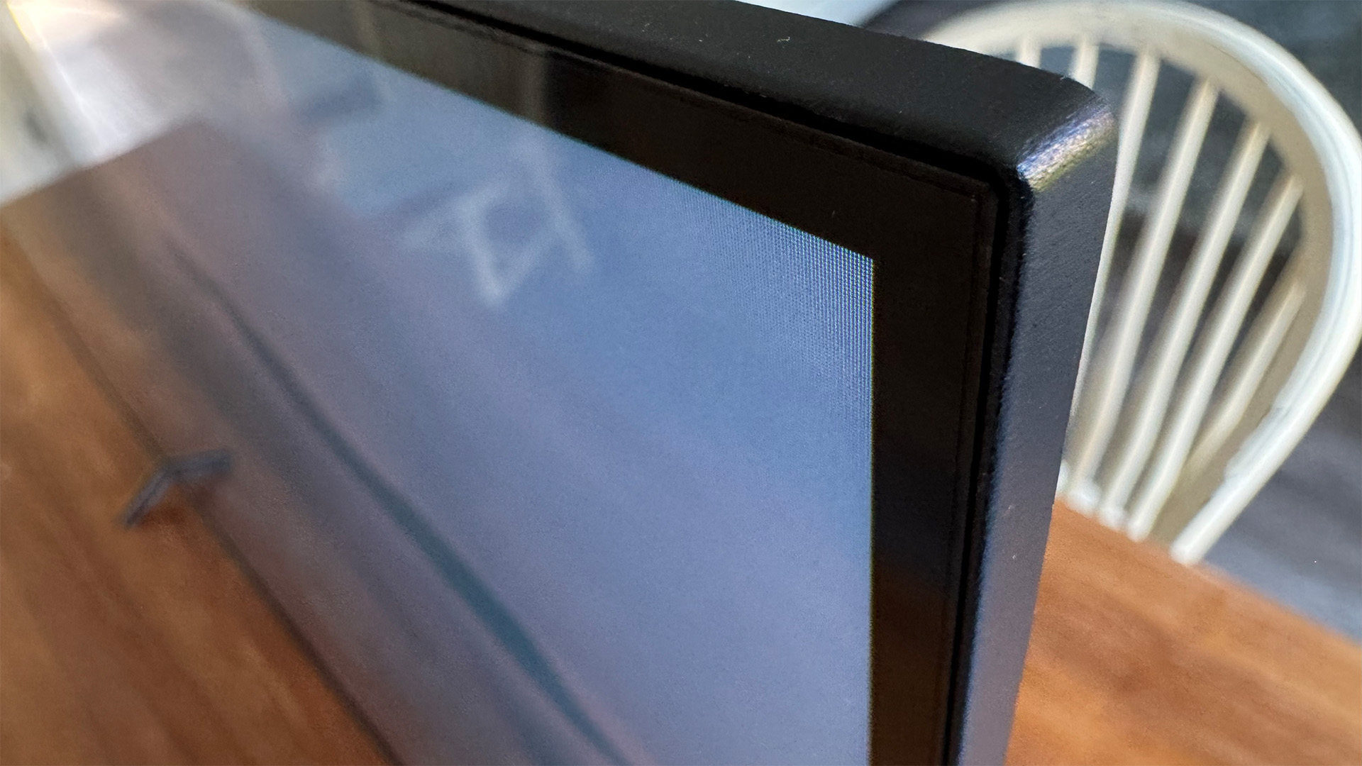 TCL P7K 43-inch TV on wooden table showing top corner of screen