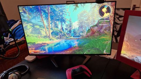 Philips Momentum 5000 on a desk displaying Tiny Tina's Wonderlands. At the bottom of the screen we can see a pink DualSense also on the desk
