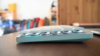 A white Logitech MX Keys Mini for Mac keyboard sitting on a desk