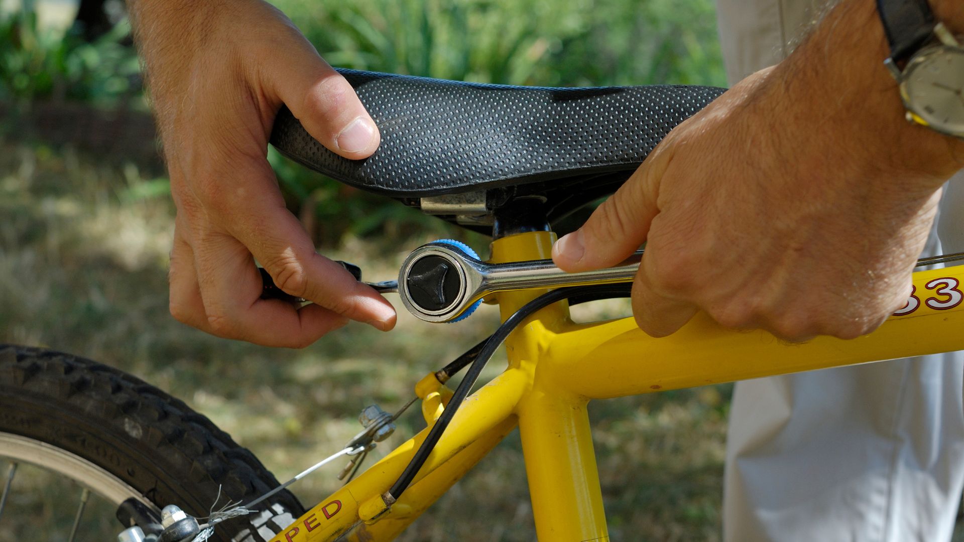 Woman adjusting bike saddle