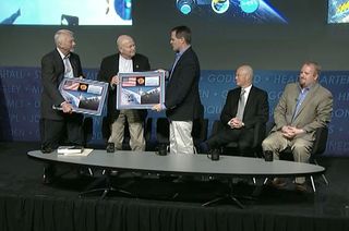 International Space Station Expedition 34 commander Kevin Ford (right) presents Skylab astronauts Owen Garriott (left) and Gerald Carr with space-flown flags to mark the 40th anniversary of their missions on board America's first space station, May 13, 2013 at NASA Headquarters in Washington, D.C.