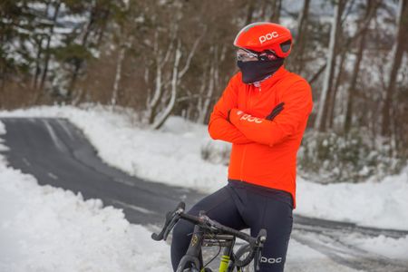 rider by the side of the road warms himself