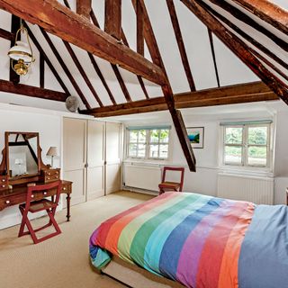 bedroom with white wall and wooden beams