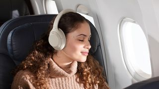 Sony WH-1000XM4 worn by a woman on an airplane