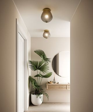 Orbiform Ceiling Light by Lime Lace in neutral beige hallway with palm plant and round mirror