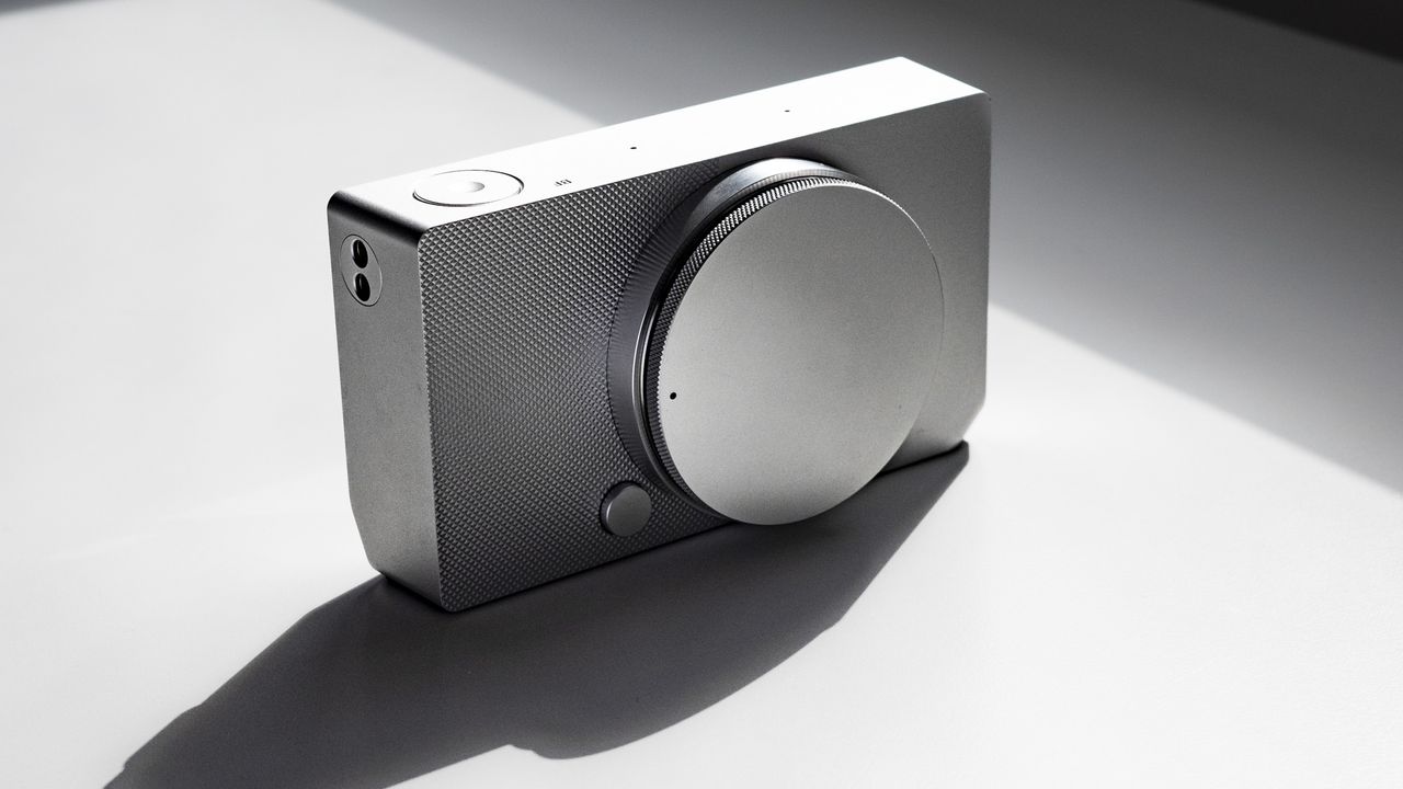 Sigma BF with its body cap, on a white surface in strong light, with defined shadows
