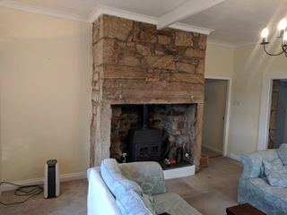 'Before' shot of exposed brick fireplace