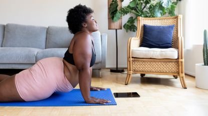 A woman stretching in her living room 