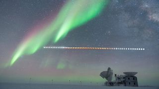 The arch of the Milky Way above the South Pole Telescope amid the progressing lunar eclipse accompanied by a magnificent aurora display.