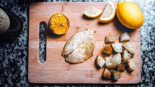 Fish and lemon on chopping board