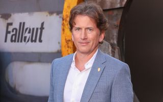 Todd Howard in front of a sign saying Fallout