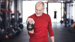 Senior man lifting a kettlebell