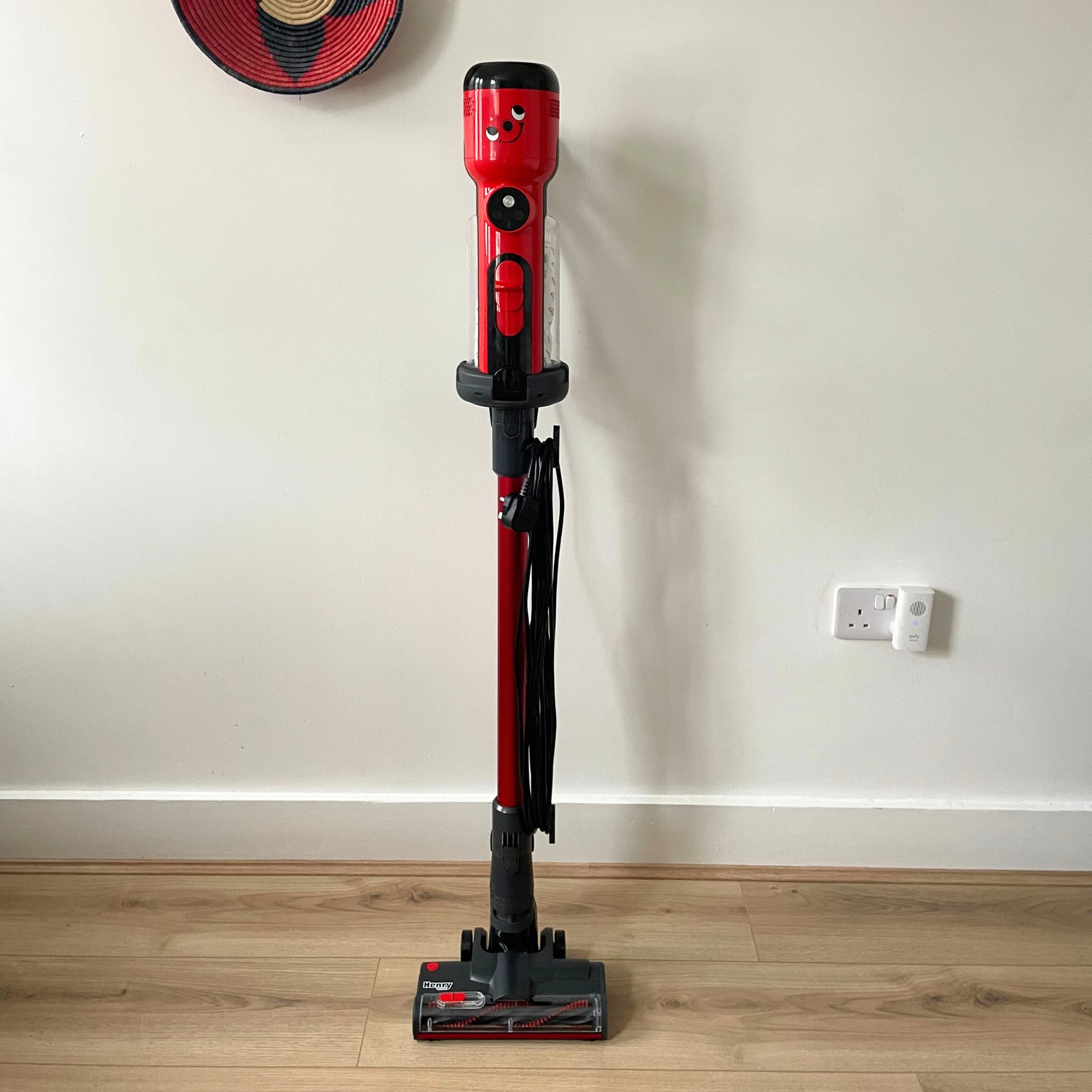 Henry Quick Corded Vacuum Cleaner on wood-effect flooring, standing in front of a white wall