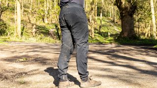 Back of man wearing Rapha Trail Gore-Tex pants with woods behind