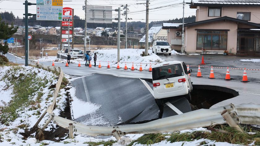 A photo of a car on the edge of a collapsed road in Tohoku town, Japan, following a 7.6 magnitude earthquake. 