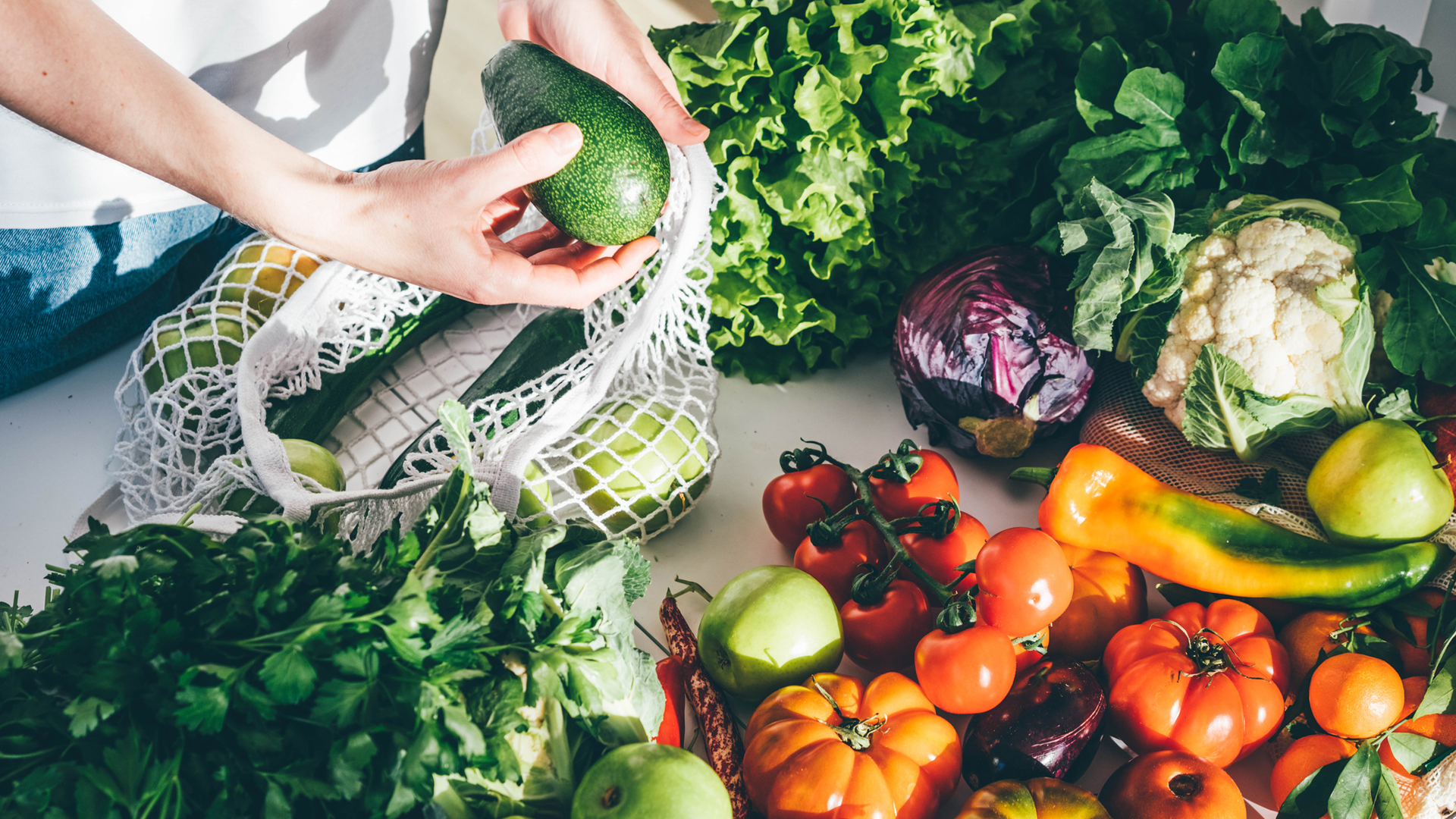 woman unpacking fresh organic vegetables