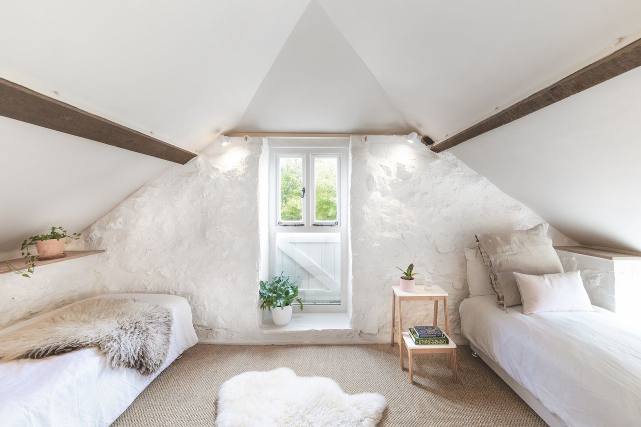 stone bedroom in loft with two single beds