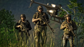 Three soldiers in camo holding guns and walking through long grass