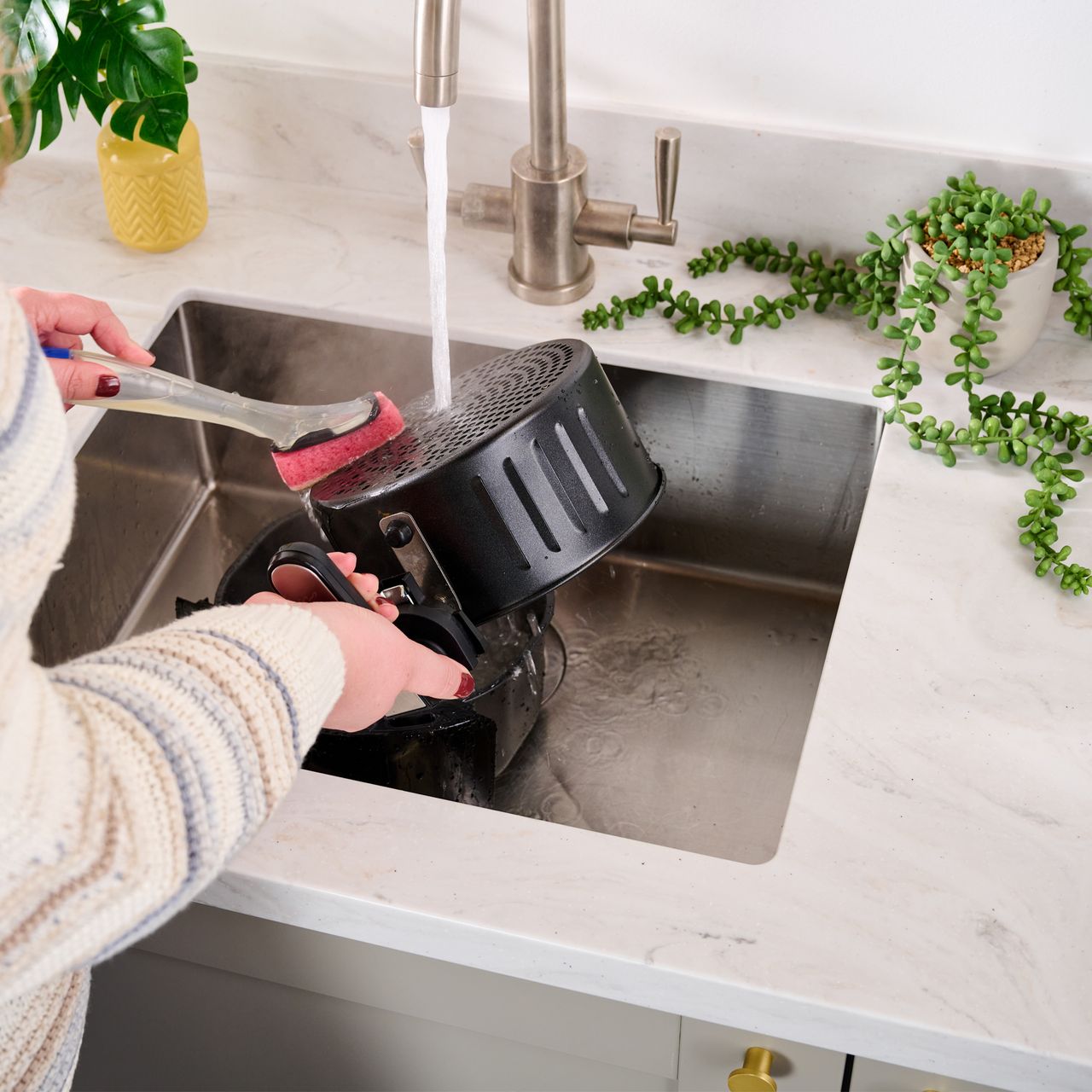 Image of air fryer basket being cleaned