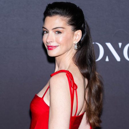 Anne Hathaway was spotted in NYC wearing light-wash jeans, a bright red blazer, and fuchsia pumps, a most interesting color combination