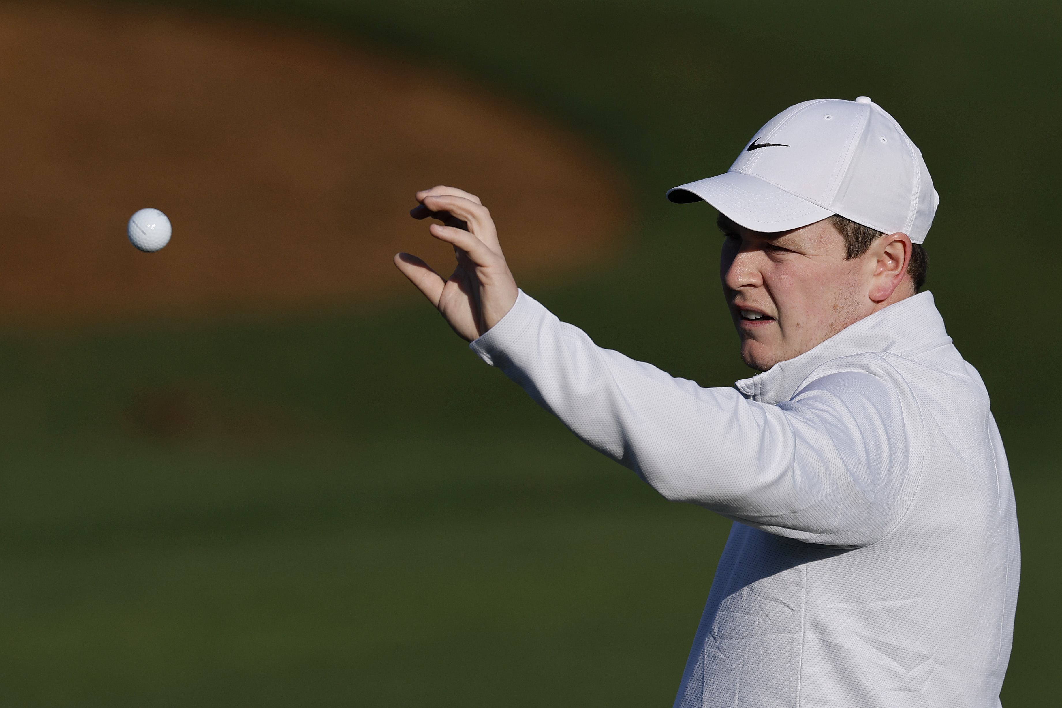 Robert MacIntyre catches a golf ball